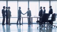 Businesspeople shaking hands at a meeting